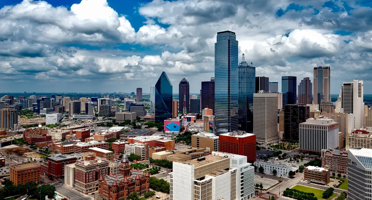 Downtown Dallas skyline under dramatic clouds