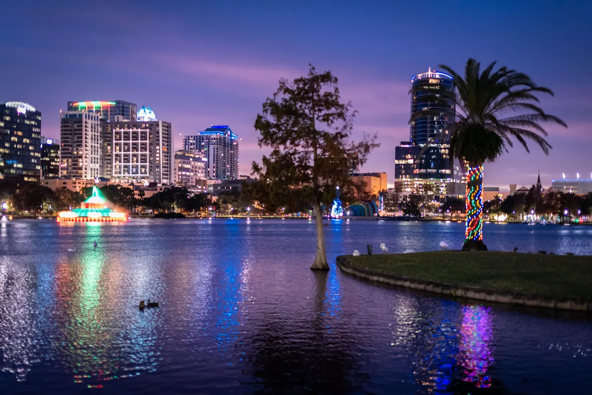 Downtown Orlando skyline and Lake Eola at dusk with holiday lights