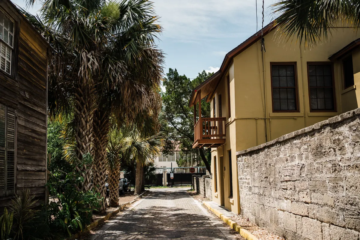 Historic brick street lined with palm trees in Ybor City, Tampa